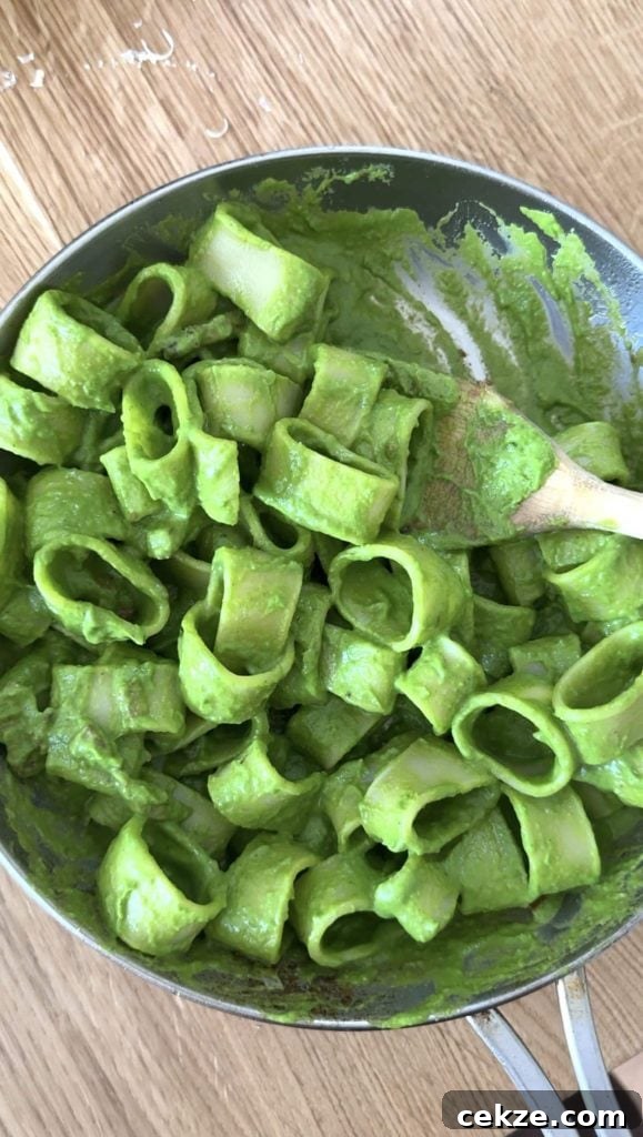 Creamy Spinach Pesto Pasta with Garlic and Lemon 11 pasta in green sauce in a silver frying pan