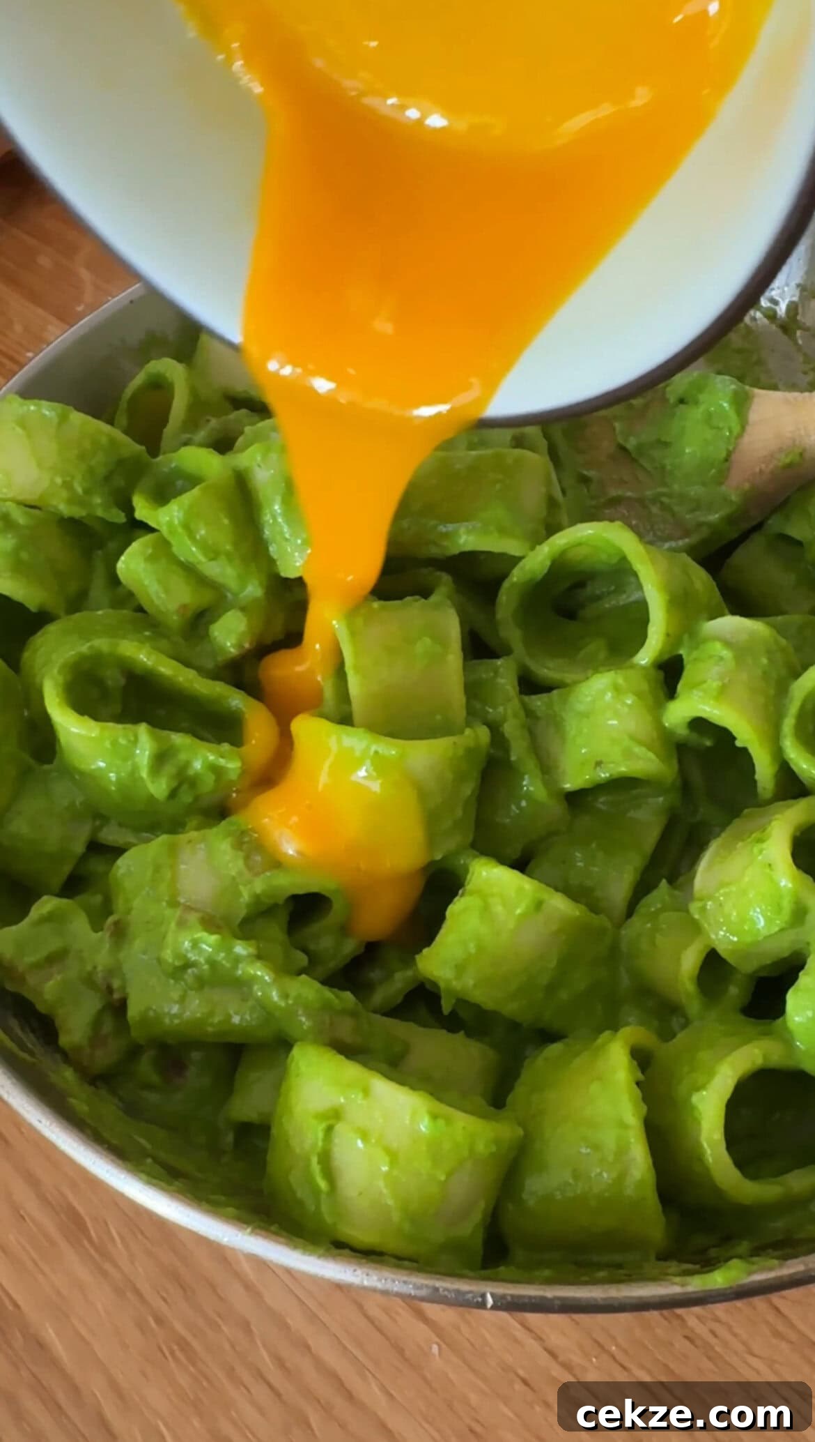 Creamy Spinach Pesto Pasta with Garlic and Lemon 8 ADDING EGG YOLKS TO PASTA IN GREEN SAUCE