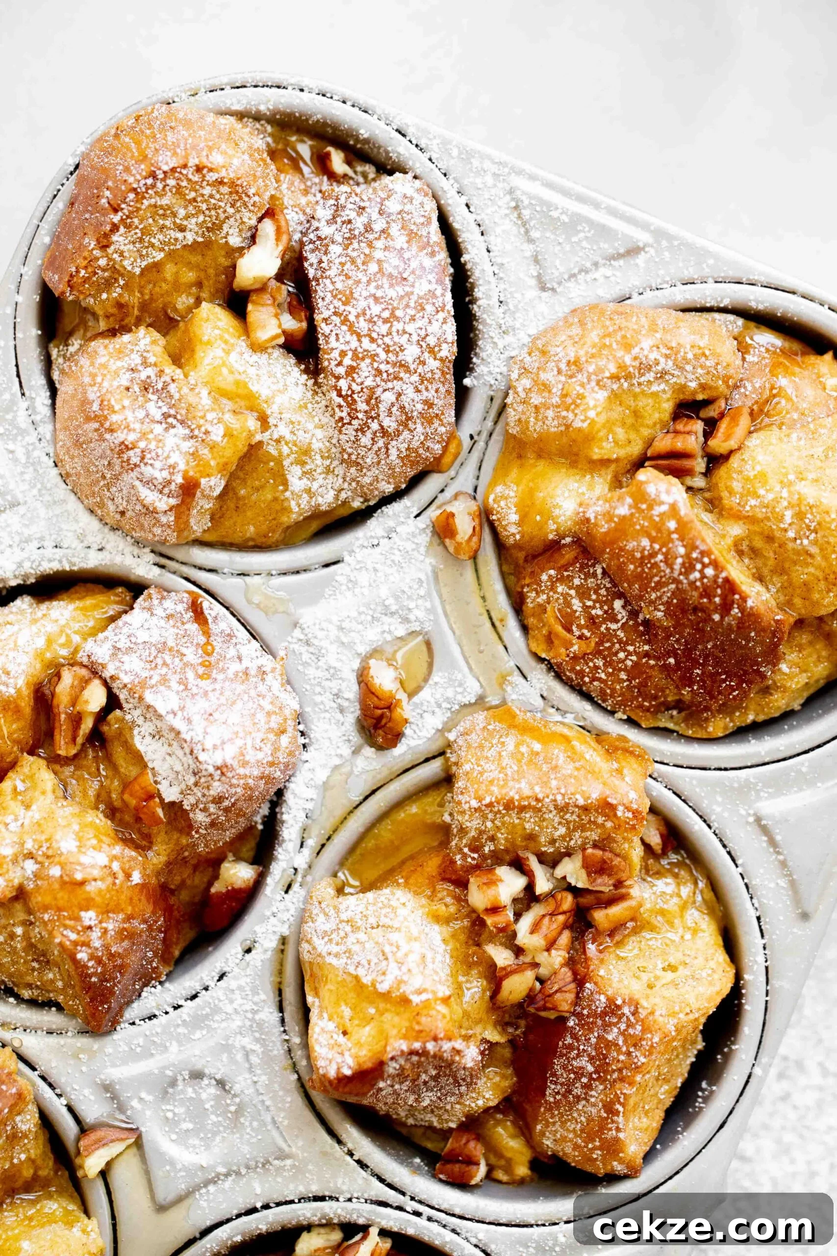 closeup overhead photo of french toast muffins in aluminum muffin tin