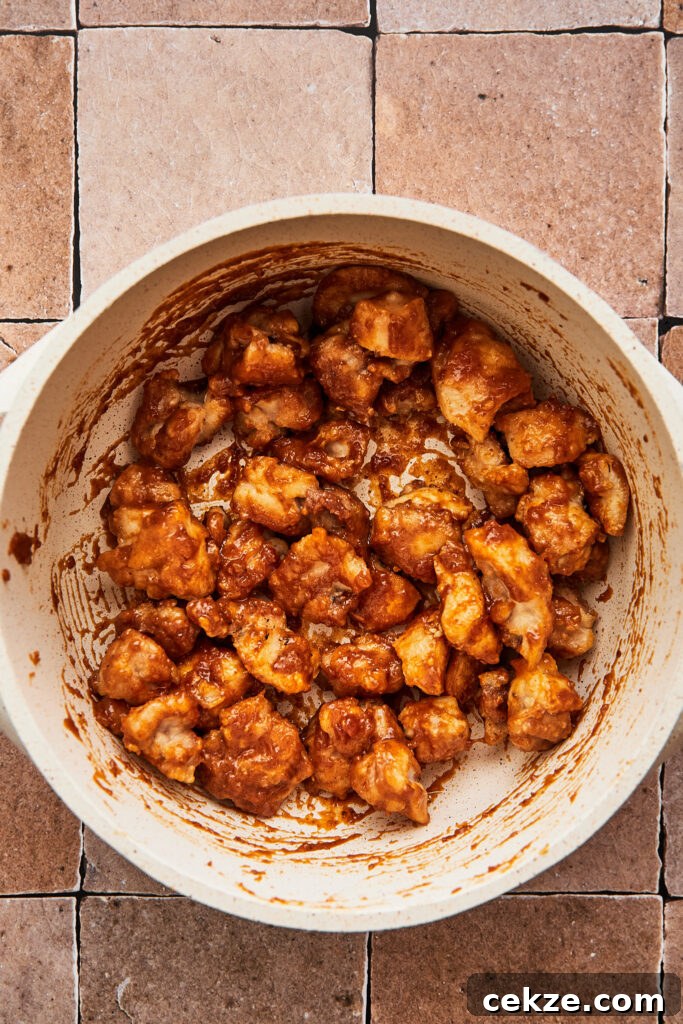 cooked sesame chicken tossed in a sauce