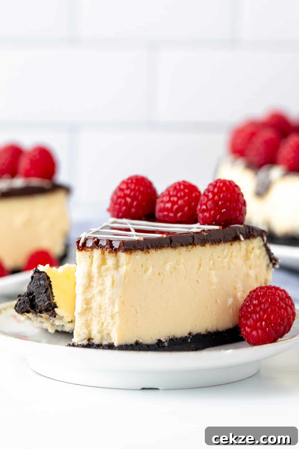 Slice of white chocolate raspberry cheesecake with bite taken out