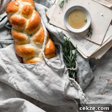 Braided loaf of bread wrapped in linen.