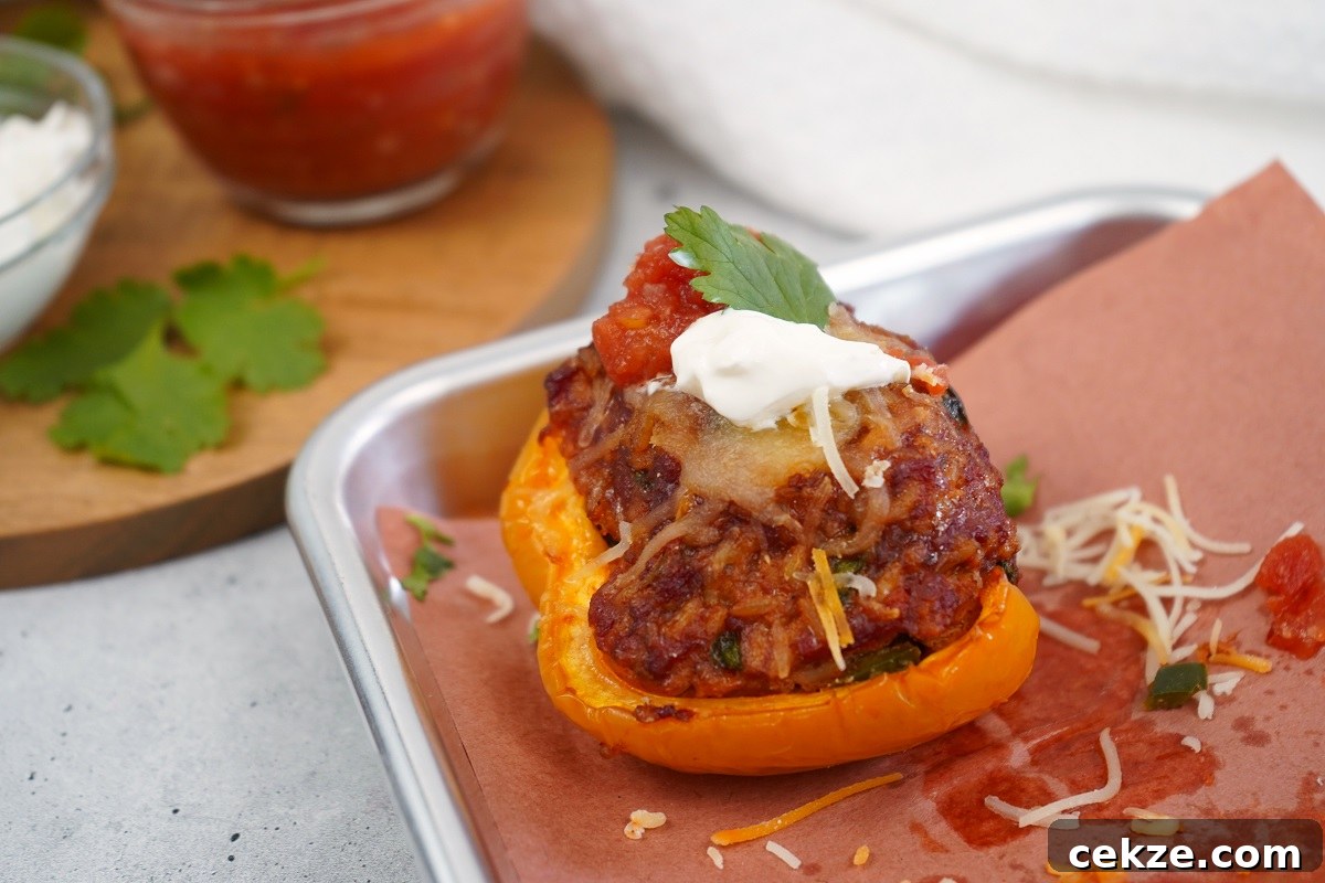 Smoked chorizo stuffed peppers with sour cream and salsa.