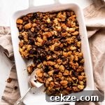 A white casserole dish of made-from-scratch Thanksgiving Stuffing.