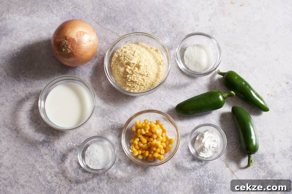 Onions, jalapeños, and small bowls with milk, cornmeal, sugar, baking powder, salt, and corn.