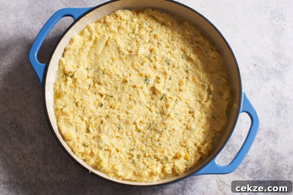 Spoonbread dough in a casserole pan ready for baking.