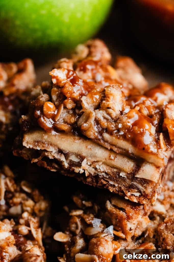 A close-up on a apple pie bar drizzled with salted caramel sauce.