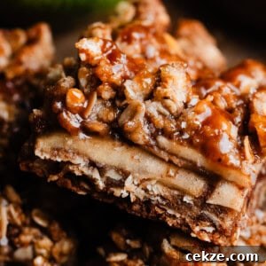A close-up of an apple pie bar drizzled with salted caramel sauce.