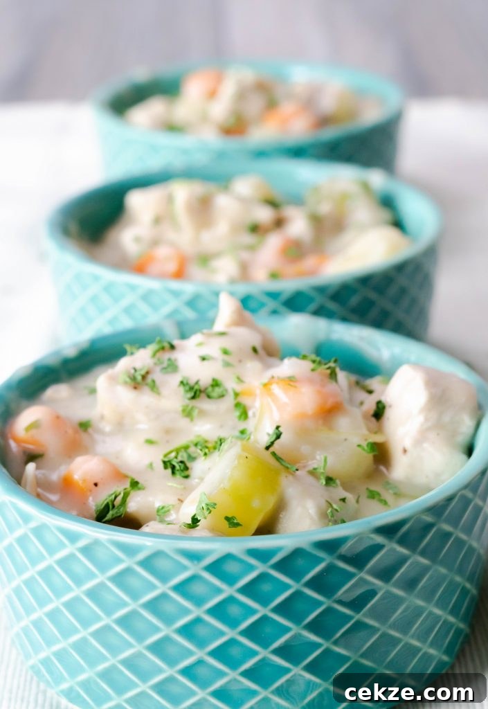 Mini Chicken Pot Pie in a blue ramekin without puff pastry top.