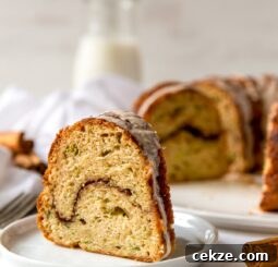 slice of cinnamon zucchini bundt cake with cinnamon swirl in the center